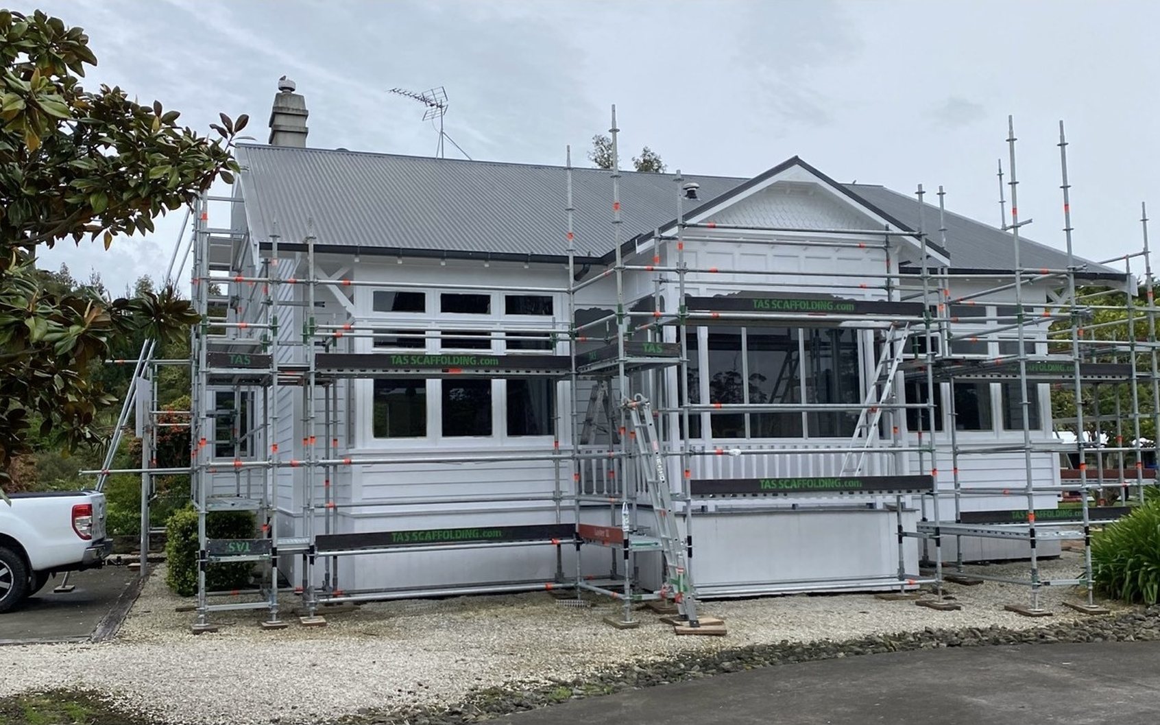 Before: villa in scaffold, then the finished white villa