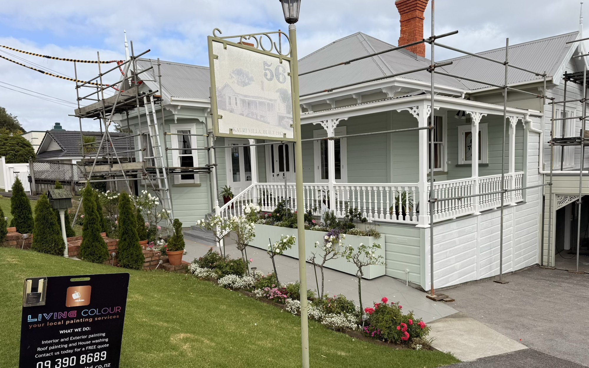 Before: 1912 kauri villa in scaffold with faded sage weatherboards, then finished in soft duck-egg blue with crisp white trim and fretwork